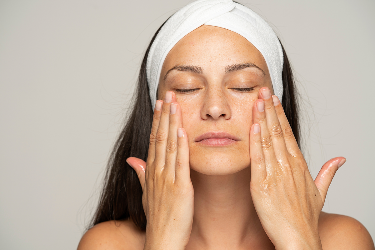 A young woman massaging her face